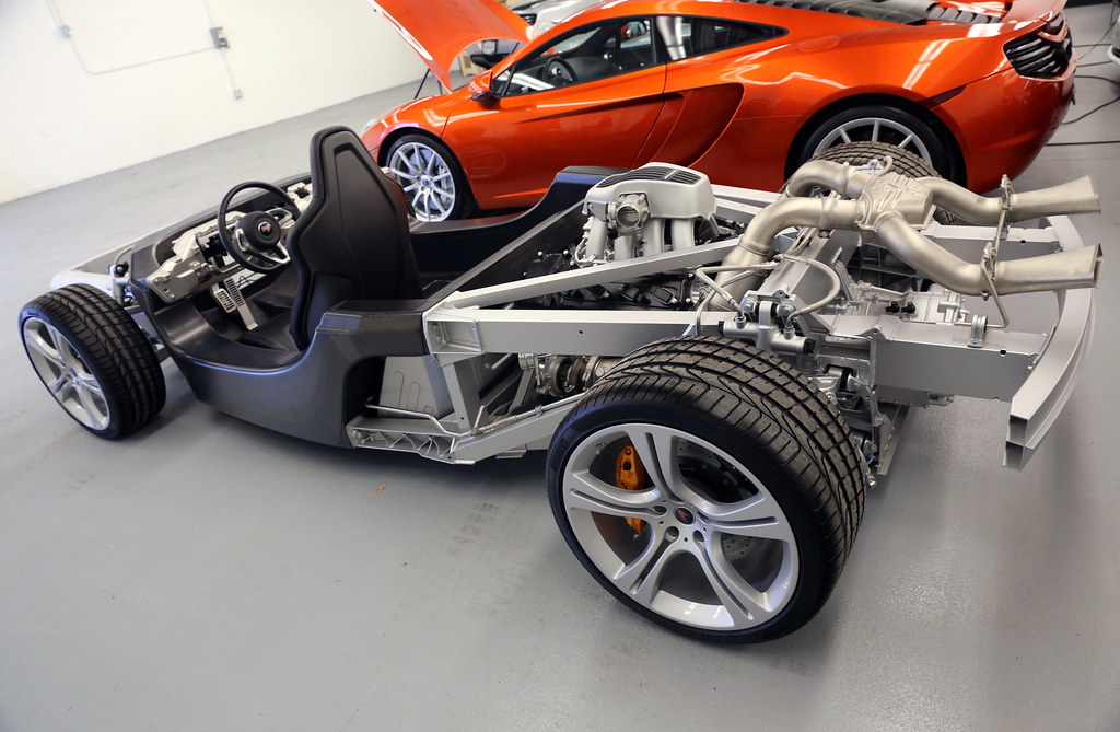 Professional auto service dealership with modern equipment and technicians in workspace